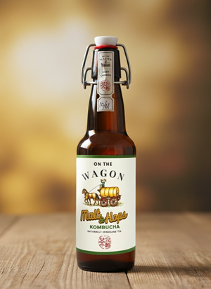 Bottle of 'On the Wagon' Malt Hops Kombucha on a wooden surface with a blurred background