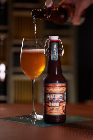 On The Wagon Kombucha x Lai Ching Heen Regent Hotel custom Earl Grey label bottle and a glass of kombucha