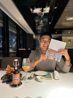 A bottle of On The Wagon Kombucha with special label for Lai Ching Heen restaurant in Regent Hotel Hong Kong with Alvin Lam, the painter of the custom label